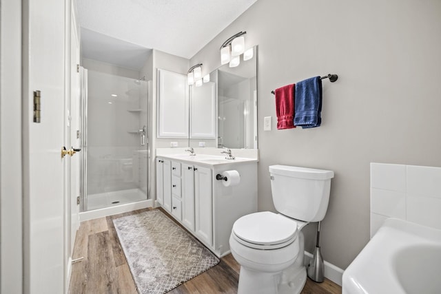 4345 Merrimac Ln N Unit 7, Plymouth, MN 55446 - bathroom with wood finished floors, double vanity, toilet, an enclosed shower, and a garden tub