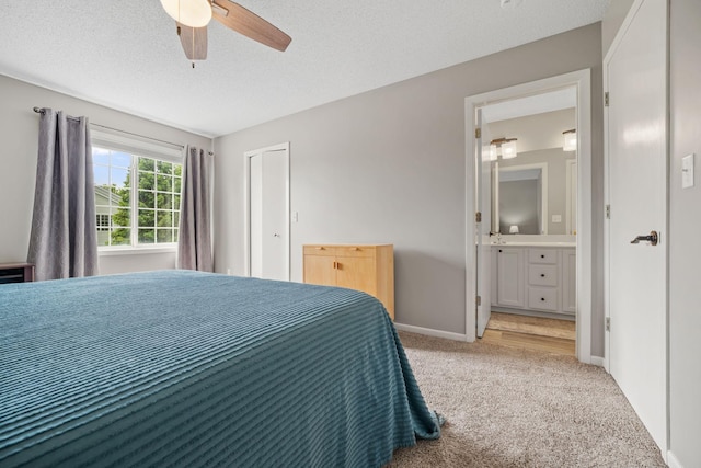 4345 Merrimac Ln N Unit 7, Plymouth, MN 55446 - bedroom featuring light colored carpet, baseboards, a textured ceiling, ensuite bath, and a ceiling fan
