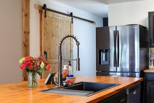 3250 Wild Turkey Ln, Red Wing, MN 55066 - kitchen with wooden counters, stainless steel fridge, and a barn door