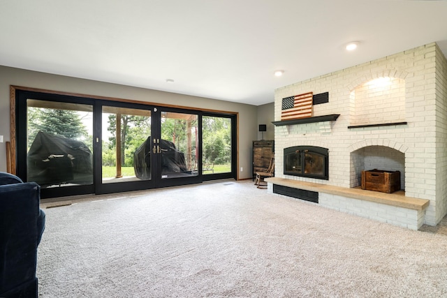 3250 Wild Turkey Ln, Red Wing, MN 55066 - unfurnished living room with carpet floors, a fireplace, and healthy amount of natural light