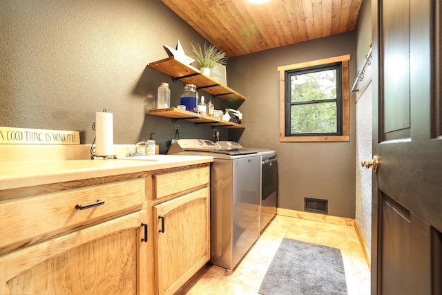 3250 Wild Turkey Ln, Red Wing, MN 55066 - laundry area with cabinet space, washing machine and dryer, wooden ceiling, and light tile patterned floors