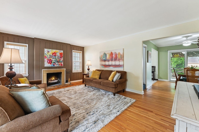 5718 13th Ave S, Minneapolis, MN 55417 - living room with baseboards, light wood finished floors, ornamental molding, a fireplace with flush hearth, and ceiling fan