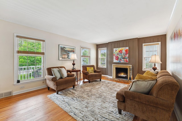 5718 13th Ave S, Minneapolis, MN 55417 - living area with healthy amount of natural light, baseboards, a fireplace with flush hearth, wood finished floors, and ornamental molding