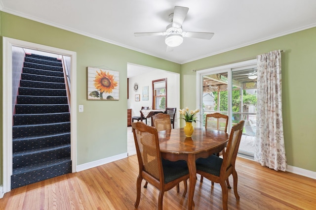 5718 13th Ave S, Minneapolis, MN 55417 - dining room featuring light wood finished floors, baseboards, ornamental molding, stairs, and ceiling fan