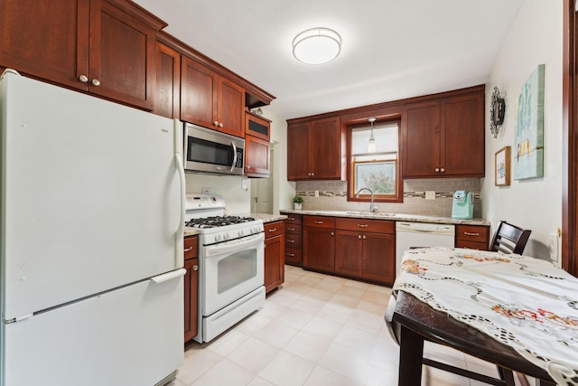 5718 13th Ave S, Minneapolis, MN 55417 - kitchen featuring white appliances, a sink, tasteful backsplash, light stone counters, and pendant lighting