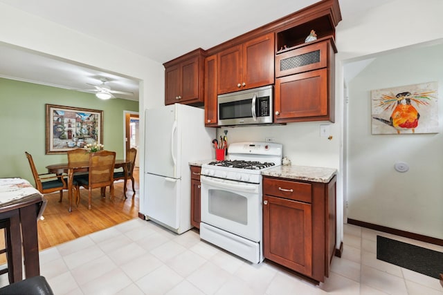 5718 13th Ave S, Minneapolis, MN 55417 - kitchen featuring white appliances, ceiling fan, and light stone counters