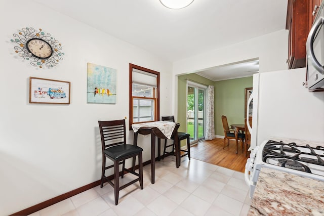 5718 13th Ave S, Minneapolis, MN 55417 - dining room featuring baseboards, light tile patterned flooring, and ornamental molding