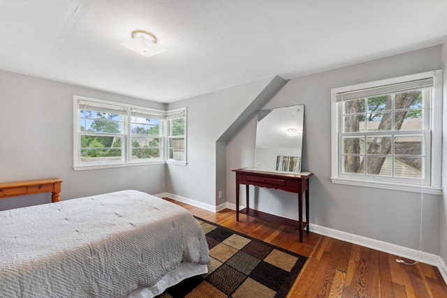 5718 13th Ave S, Minneapolis, MN 55417 - bedroom with multiple windows, wood finished floors, and baseboards