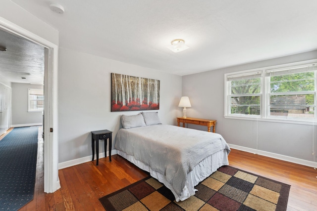 5718 13th Ave S, Minneapolis, MN 55417 - bedroom featuring wood finished floors, multiple windows, and baseboards