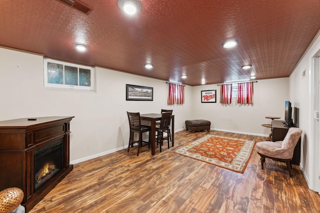 5718 13th Ave S, Minneapolis, MN 55417 - sitting room with wood finished floors, a warm lit fireplace, and baseboards