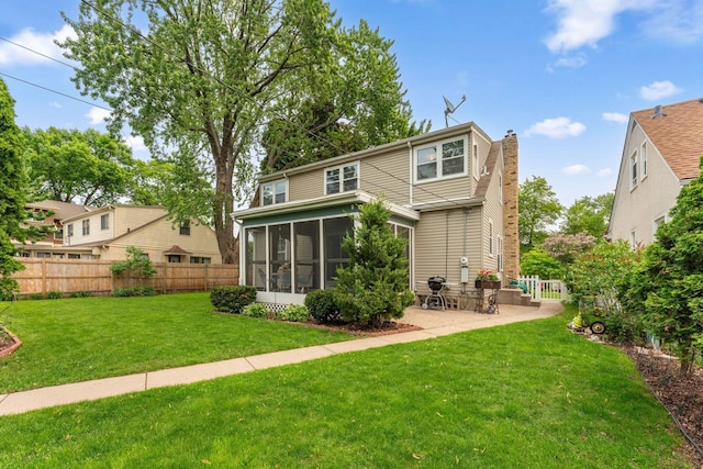 5718 13th Ave S, Minneapolis, MN 55417 - back of house featuring a sunroom, a chimney, and a patio