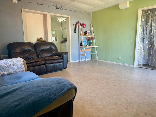 114 Thompson Ave, Rushmore, MN 56168 - living room with a drop ceiling, a ceiling fan, and wood walls