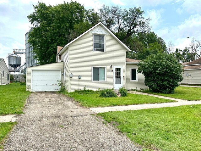 114 Thompson Ave, Rushmore, MN 56168 - traditional-style house featuring a garage, a front lawn, and driveway