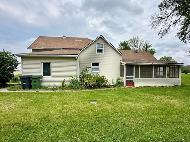 114 Thompson Ave, Rushmore, MN 56168 - rear view of property featuring a sunroom, roof with shingles, and a yard