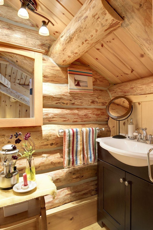 9453 Little Elbow Lk N, Cook, MN 55723 - bathroom featuring log walls, wood ceiling, vanity, and lofted ceiling