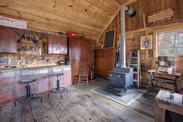 9453 Little Elbow Lk N, Cook, MN 55723 - kitchen with a wood stove, hardwood / wood-style floors, vaulted ceiling, wooden walls, and wooden ceiling