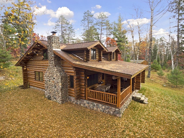 9453 Little Elbow Lk N, Cook, MN 55723 - view of front of house featuring log exterior, a chimney, and roof with shingles