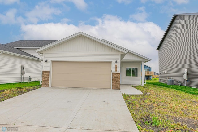 6646 68th St S, Horace, ND 58047 - craftsman-style house featuring stone siding, an attached garage, concrete driveway, and board and batten siding