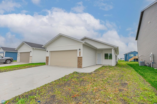 6646 68th St S, Horace, ND 58047 - view of front facade with a garage, concrete driveway, a front lawn, and board and batten siding