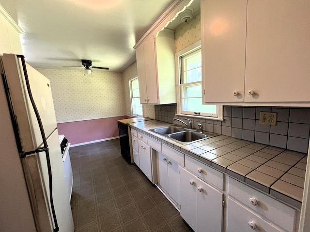 757 111th Ave NW, Coon Rapids, MN 55448 - kitchen featuring tile countertops, a sink, freestanding refrigerator, wallpapered walls, and white cabinetry