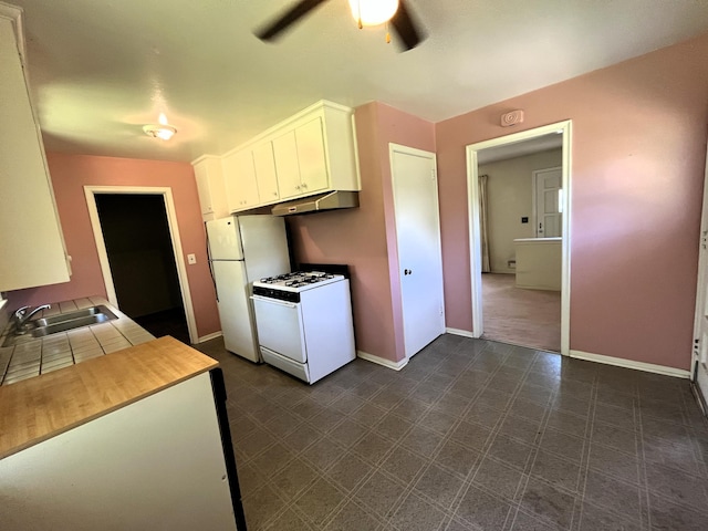 757 111th Ave NW, Coon Rapids, MN 55448 - kitchen with white appliances, a sink, a ceiling fan, white cabinets, and baseboards