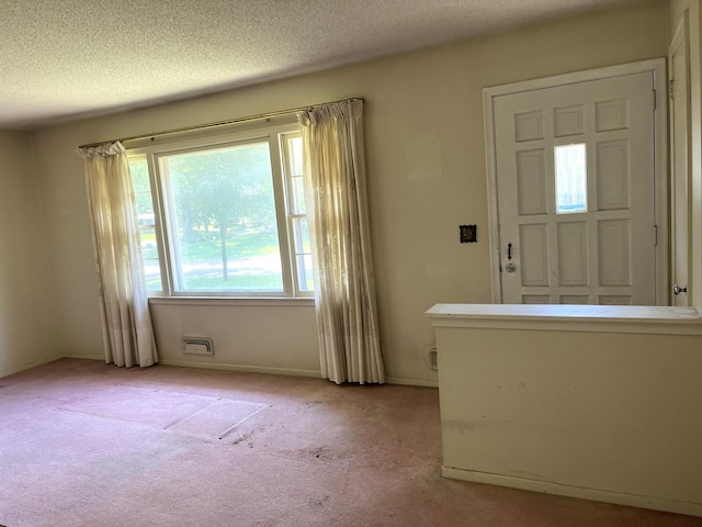 757 111th Ave NW, Coon Rapids, MN 55448 - foyer entrance featuring light colored carpet, a textured ceiling, and baseboards