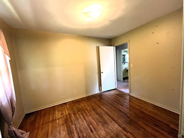 757 111th Ave NW, Coon Rapids, MN 55448 - unfurnished room with dark wood finished floors and baseboards