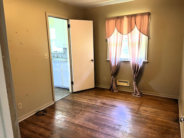 757 111th Ave NW, Coon Rapids, MN 55448 - spare room featuring dark wood-style flooring and baseboards