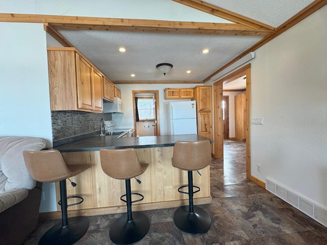 13150 Maple Circle Dr SE, Hudson Twp, MN 56334 - kitchen with white appliances, a peninsula, dark countertops, baseboards, and decorative backsplash