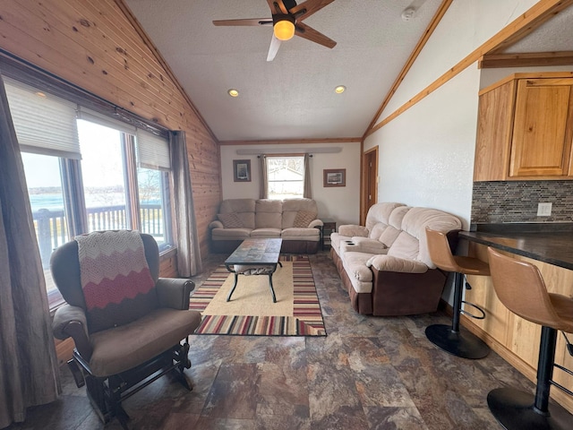 13150 Maple Circle Dr SE, Hudson Twp, MN 56334 - living room with lofted ceiling, ceiling fan, a textured ceiling, wood walls, and ornamental molding