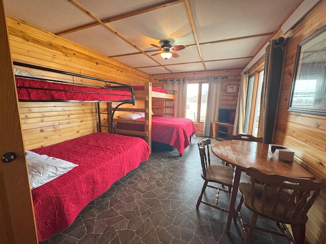 13150 Maple Circle Dr SE, Hudson Twp, MN 56334 - bedroom featuring wood walls, stone floors, and a textured ceiling