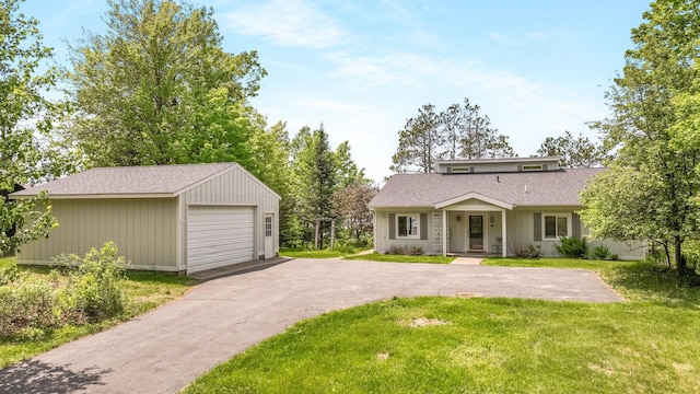 10787 Reynolds Rd, Round Lake Twp, WI 54843 - view of front of property featuring a garage, a front lawn, an outbuilding, and roof with shingles