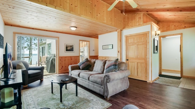 10787 Reynolds Rd, Round Lake Twp, WI 54843 - living room with wood walls, vaulted ceiling, wooden ceiling, wainscoting, and ceiling fan