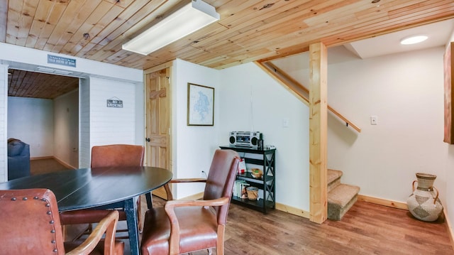 10787 Reynolds Rd, Round Lake Twp, WI 54843 - dining area with wooden ceiling, stairway, wood finished floors, and baseboards