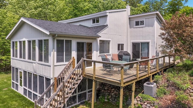 10787 Reynolds Rd, Round Lake Twp, WI 54843 - rear view of house featuring roof with shingles, central air condition unit, a sunroom, a wooden deck, and stairs