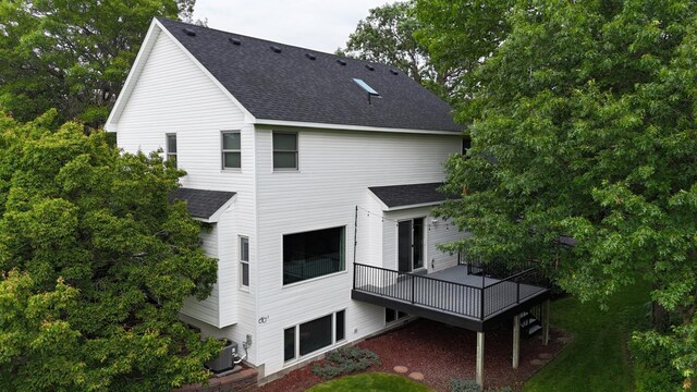 1848 141st Ln NE, Ham Lake, MN 55304 - back of house featuring roof with shingles and a wooden deck