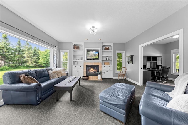 1848 141st Ln NE, Ham Lake, MN 55304 - living room with dark carpet, a tiled fireplace, an office area, and built in features