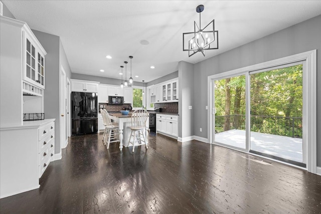1848 141st Ln NE, Ham Lake, MN 55304 - kitchen featuring black appliances, a kitchen island, decorative backsplash, recessed lighting, and a chandelier