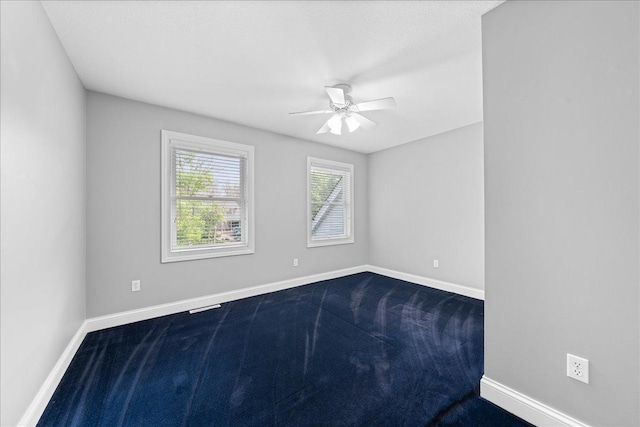 1848 141st Ln NE, Ham Lake, MN 55304 - unfurnished room featuring dark colored carpet and ceiling fan