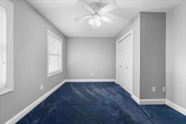 1848 141st Ln NE, Ham Lake, MN 55304 - unfurnished bedroom featuring dark colored carpet, a closet, and ceiling fan