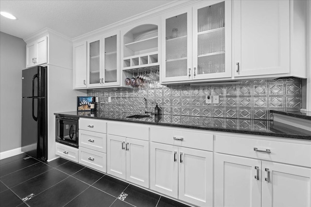 1848 141st Ln NE, Ham Lake, MN 55304 - kitchen featuring black appliances, white cabinetry, dark tile patterned floors, decorative backsplash, and dark stone countertops