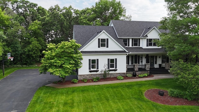 1848 141st Ln NE, Ham Lake, MN 55304 - view of front of home with a porch, roof with shingles, a front yard, stone siding, and asphalt driveway