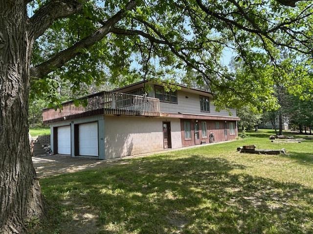 601 1st Ave, Grand Rapids, MN 55744 - back of property featuring a yard, a garage, and driveway