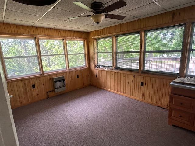 601 1st Ave, Grand Rapids, MN 55744 - unfurnished sunroom with heating unit, wooden walls, and carpet flooring
