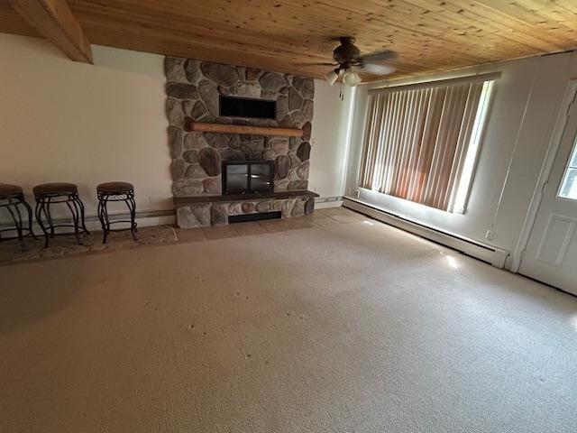 601 1st Ave, Grand Rapids, MN 55744 - living room featuring wood ceiling, a ceiling fan, a fireplace, and a baseboard heating unit