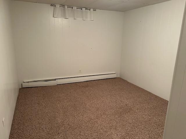 601 1st Ave, Grand Rapids, MN 55744 - carpeted empty room with a baseboard radiator
