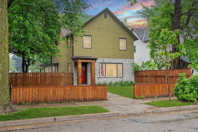 1714 5th St NE, Minneapolis, MN 55413 - traditional-style house with a fenced front yard and stucco siding