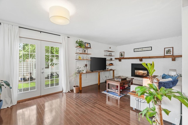 1714 5th St NE, Minneapolis, MN 55413 - living room featuring french doors, a glass covered fireplace, and wood finished floors