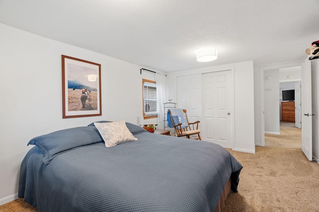 1714 5th St NE, Minneapolis, MN 55413 - bedroom with light carpet, baseboards, and a closet