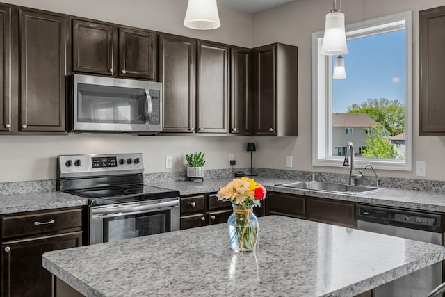 16614 74th St NE, Otsego, MN 55330 - kitchen with appliances with stainless steel finishes, a sink, dark brown cabinetry, light countertops, and pendant lighting
